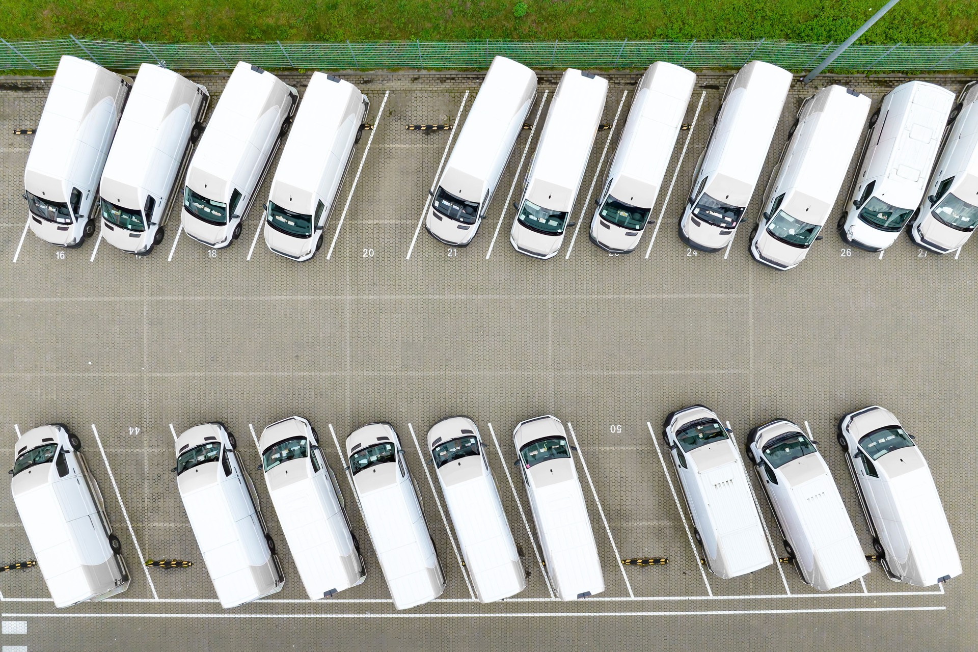 Delivery vans parked at a distribution warehouse